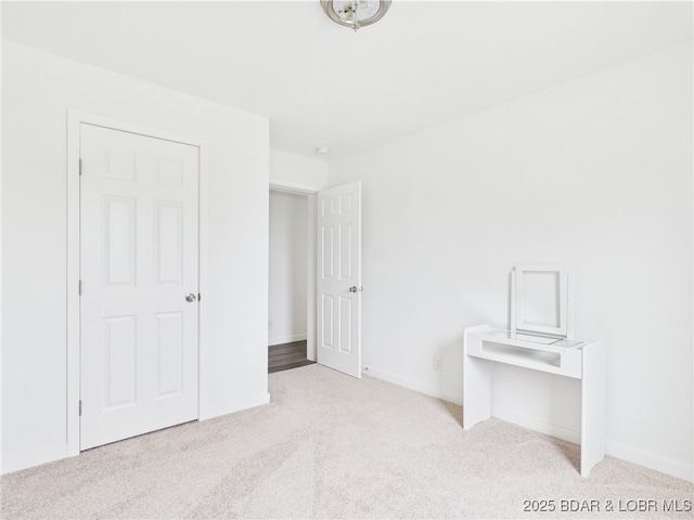unfurnished bedroom featuring baseboards and carpet flooring
