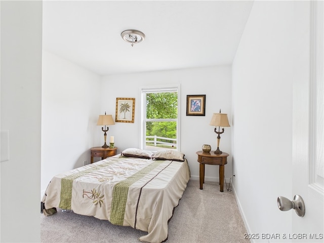 carpeted bedroom featuring baseboards