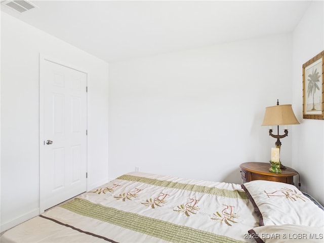 bedroom with baseboards and visible vents