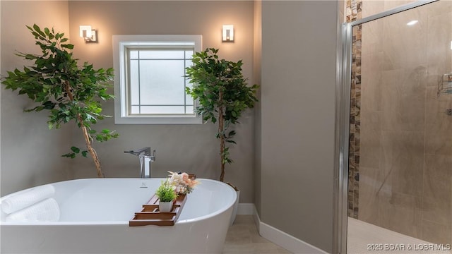 484 Hogan Dr, Lake Ozark, MO 65049 - full bathroom featuring a tile shower, a freestanding tub, and baseboards