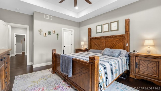 484 Hogan Dr, Lake Ozark, MO 65049 - bedroom with dark wood finished floors, baseboards, a ceiling fan, and a tray ceiling