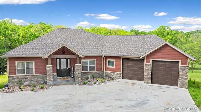 484 Hogan Dr, Lake Ozark, MO 65049 - view of front of house featuring stone siding, an attached garage, driveway, and a shingled roof