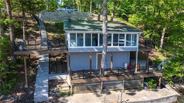 31445 Raytown Dr, Rocky Mount, MO 65072 - rear view of property featuring stairway, a wooden deck, and a sunroom