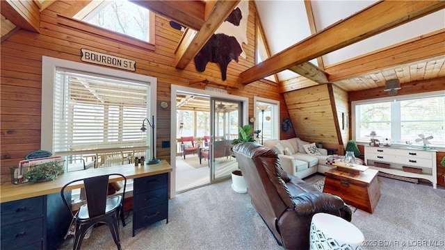 carpeted living area with beam ceiling, wooden walls, a skylight, and high vaulted ceiling