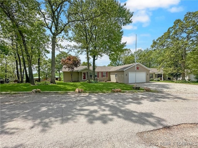 12448 Crestview Dr, Warsaw, MO 65355 - single story home featuring a front lawn, driveway, and a garage