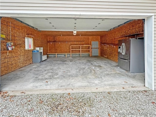 12448 Crestview Dr, Warsaw, MO 65355 - garage featuring stainless steel refrigerator with ice dispenser