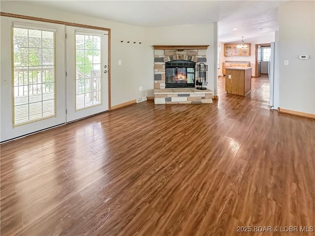 12448 Crestview Dr, Warsaw, MO 65355 - unfurnished living room featuring baseboards, dark wood-style flooring, a fireplace, and visible vents