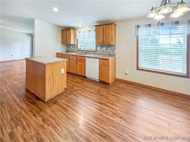 12448 Crestview Dr, Warsaw, MO 65355 - kitchen with a kitchen island, light wood-style flooring, a sink, and white dishwasher