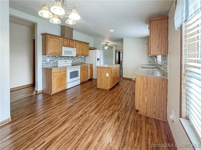 12448 Crestview Dr, Warsaw, MO 65355 - kitchen with white appliances, a kitchen island, light countertops, and backsplash