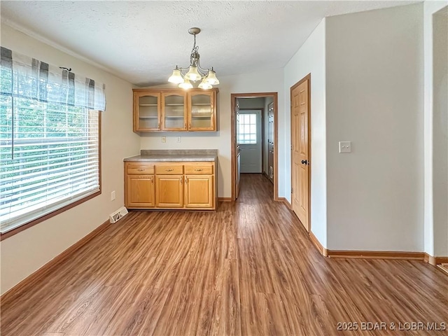 12448 Crestview Dr, Warsaw, MO 65355 - unfurnished dining area with baseboards, light wood-type flooring, and visible vents