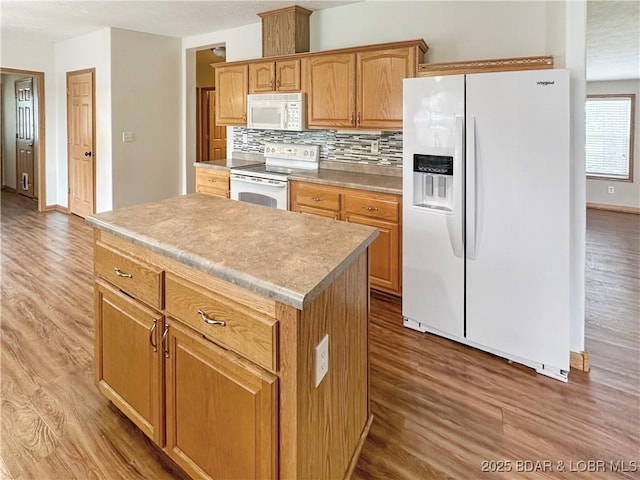 12448 Crestview Dr, Warsaw, MO 65355 - kitchen featuring backsplash, white appliances, light wood finished floors, and a kitchen island