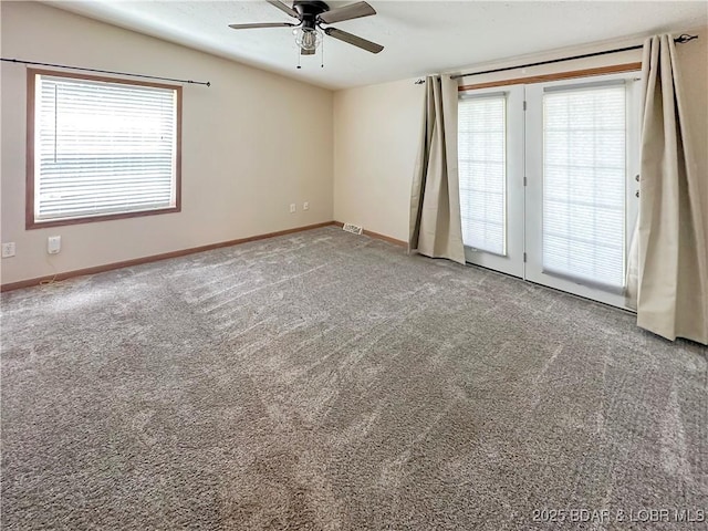 12448 Crestview Dr, Warsaw, MO 65355 - empty room with a ceiling fan, baseboards, a healthy amount of sunlight, and carpet