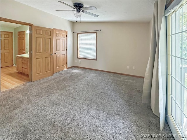 12448 Crestview Dr, Warsaw, MO 65355 - unfurnished bedroom with light carpet, baseboards, and ceiling fan