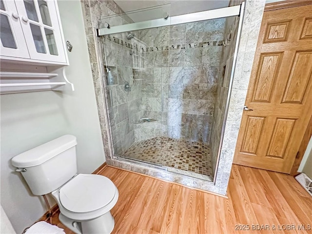 12448 Crestview Dr, Warsaw, MO 65355 - bathroom with toilet, baseboards, a shower stall, and wood finished floors