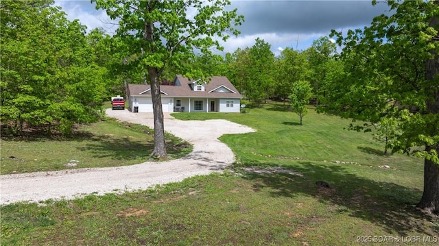 93 Misty Meadows Ln, Camdenton, MO 65020 - cape cod-style house featuring asphalt driveway, an attached garage, and a front yard