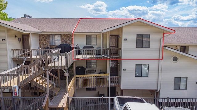 58 Jonathan Dr Unit 4B, Lake Ozark, MO 65049 - view of front of property featuring stairway and roof with shingles