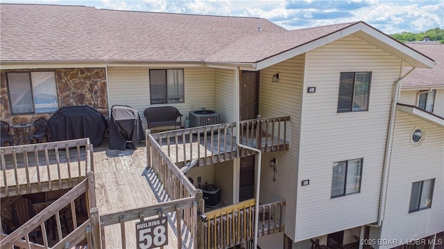 58 Jonathan Dr Unit 4B, Lake Ozark, MO 65049 - rear view of property featuring cooling unit, a shingled roof, and a wooden deck