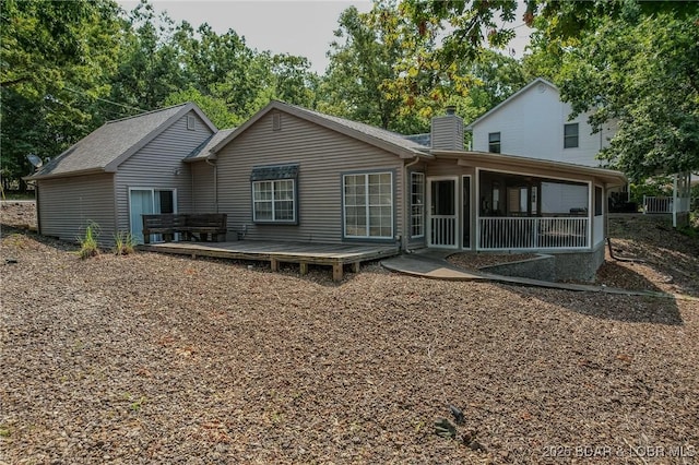 141 Wye Dr, Lake Ozark, MO 65049 - rear view of property with a chimney, a deck, and a sunroom