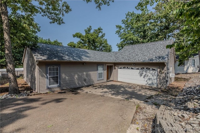 141 Wye Dr, Lake Ozark, MO 65049 - view of front of property with a garage, driveway, and a shingled roof