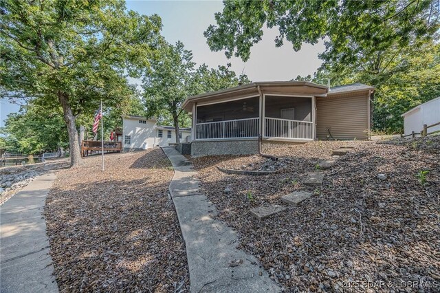 141 Wye Dr, Lake Ozark, MO 65049 - rear view of house with a sunroom
