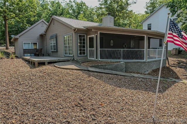141 Wye Dr, Lake Ozark, MO 65049 - rear view of house featuring a sunroom and a chimney