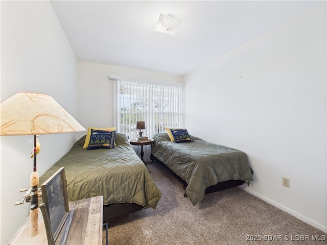 bedroom featuring carpet and baseboards