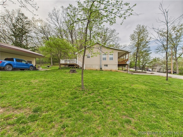 view of green lawn with a deck