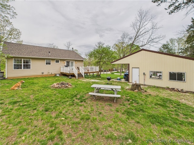 view of grassy yard with a wooden deck