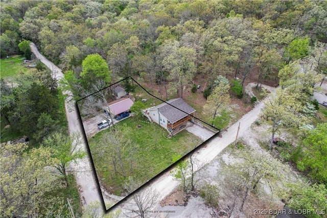 view of subject property featuring a forest