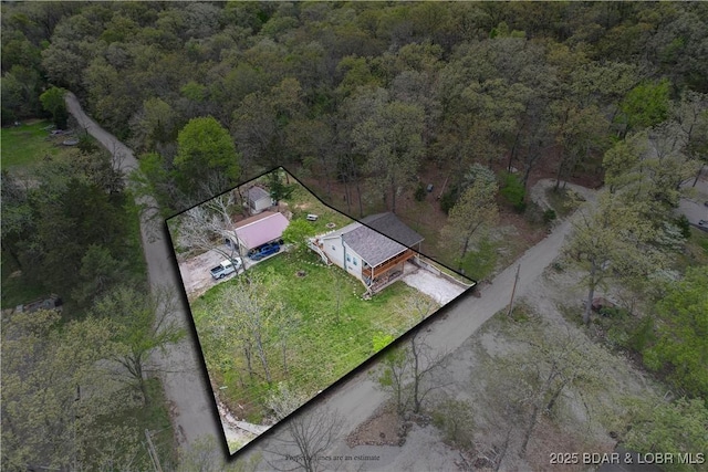aerial view of property and surrounding area with a forest and property boundaries highlighted