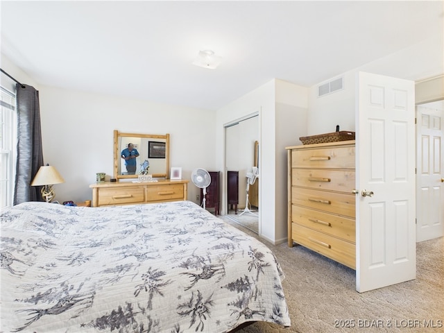 bedroom with light colored carpet and a closet