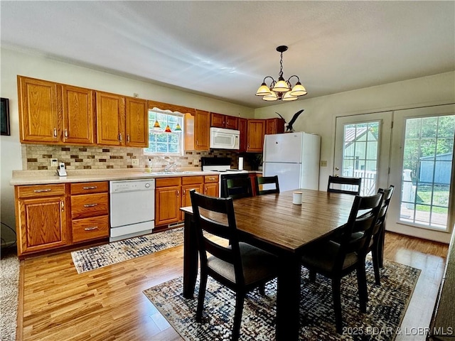 34 Glenmeadows Ct, Linn Creek, MO 65052 - dining area featuring plenty of natural light, light wood-type flooring, and a chandelier