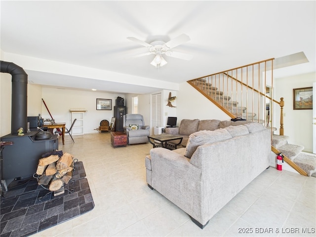 34 Glenmeadows Ct, Linn Creek, MO 65052 - living area with stairs, a ceiling fan, light tile patterned floors, and a wood stove