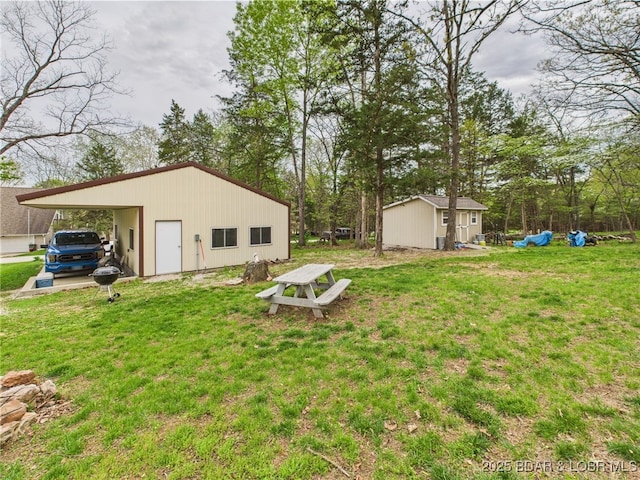 34 Glenmeadows Ct, Linn Creek, MO 65052 - view of grassy yard featuring an outdoor structure and a carport