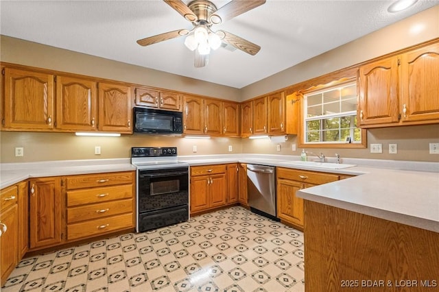 kitchen featuring black microwave, dishwasher, electric range, a sink, and brown cabinets
