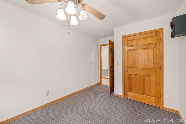 empty room featuring ceiling fan, carpet, and baseboards