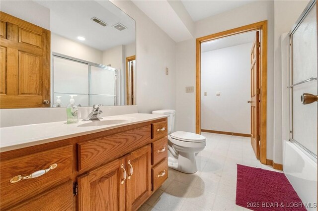 bathroom featuring an enclosed shower, toilet, vanity, tile patterned floors, and baseboards