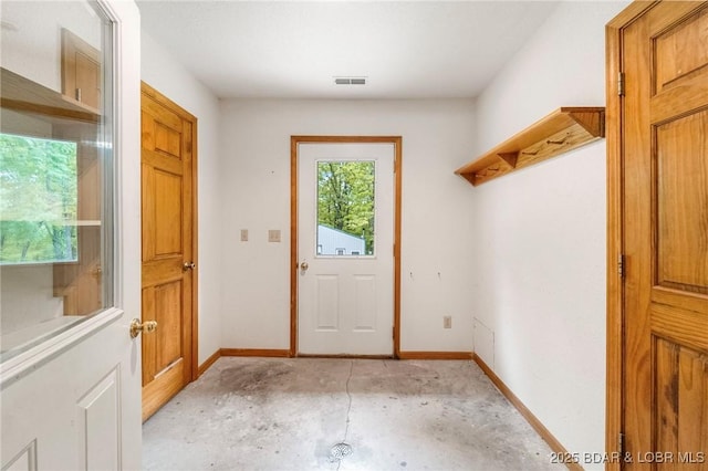mudroom with unfinished concrete flooring and baseboards