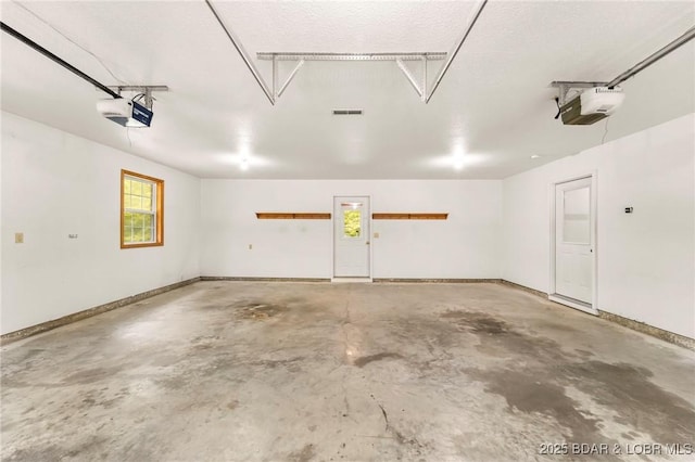 garage featuring a garage door opener and baseboards