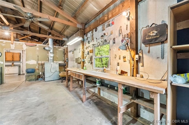 below grade area with a workshop area and a ceiling fan