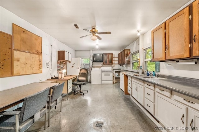 kitchen with separate washer and dryer, white appliances, a sink, and plenty of natural light