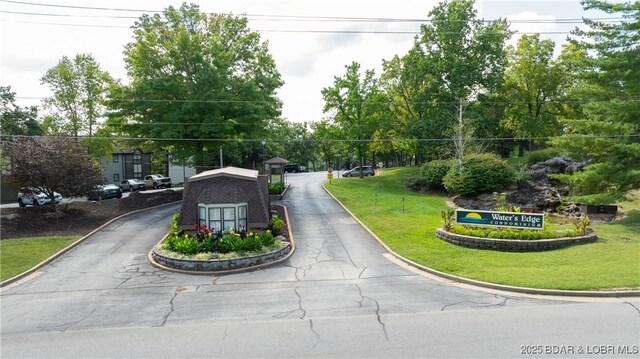 view of asphalt road with curbs