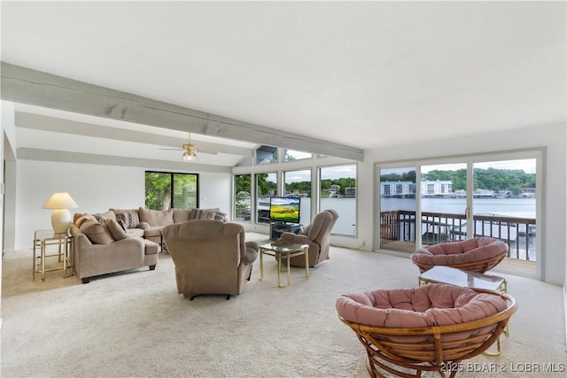 living room featuring light carpet, healthy amount of natural light, vaulted ceiling, and a ceiling fan