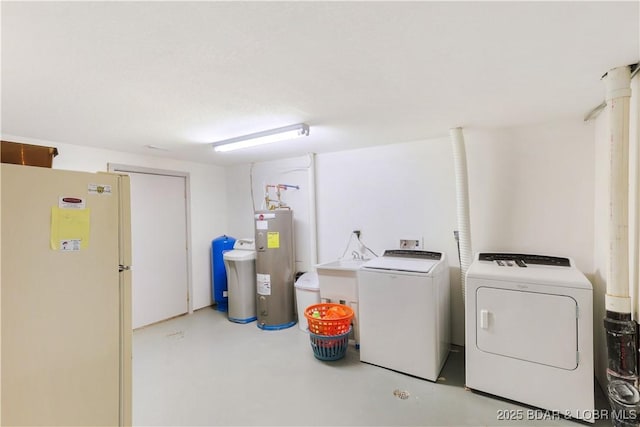 clothes washing area with electric water heater and washing machine and dryer
