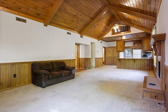 217 Westview Rd, Climax Springs, MO 65324 - living room featuring wood walls, wainscoting, wood ceiling, beam ceiling, and light carpet