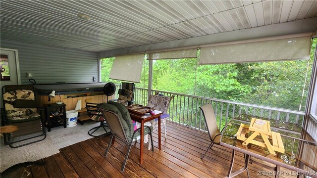 deck featuring a hot tub and outdoor dining area