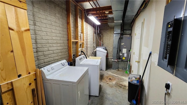 laundry room featuring washer and clothes dryer, heating unit, and electric panel