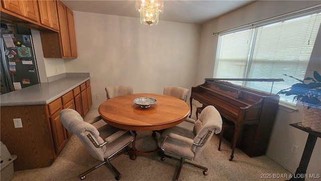 dining space featuring light colored carpet
