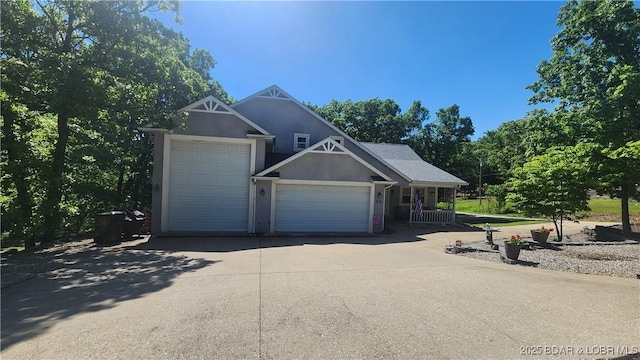 view of front of home featuring an attached garage, stucco siding, and driveway