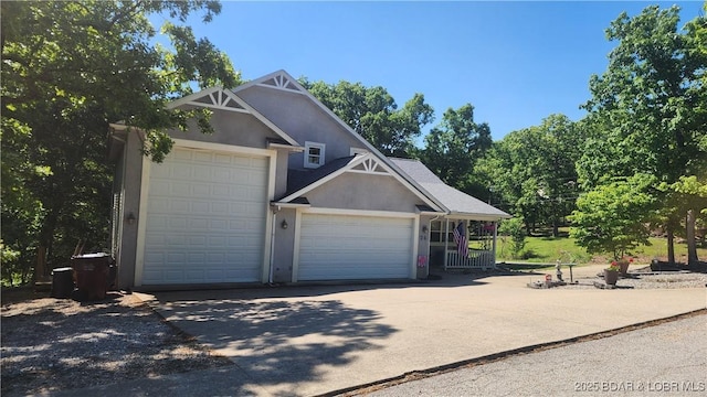 garage featuring concrete driveway